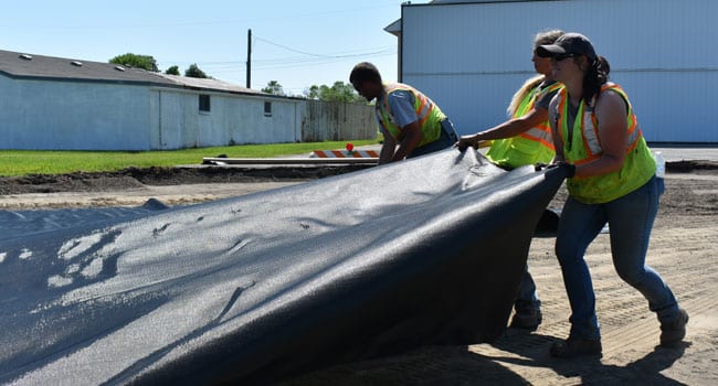 Rolling out Geotextile Fabric